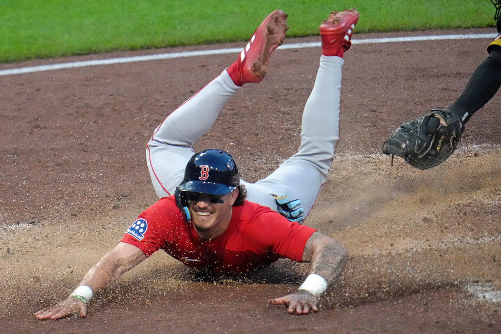 Boston Red Sox's Jarren Duran slides past the glove of Pittsburgh Pirates catcher Henry Davis to score from third on a sacrifice fly by Nick Sogard off Pirates pitcher Bubba Chandler during the fifth inning of a baseball game in Pittsburgh, Friday, Aug. 14, 2026. (AP Photo/Gene J. Puskar)