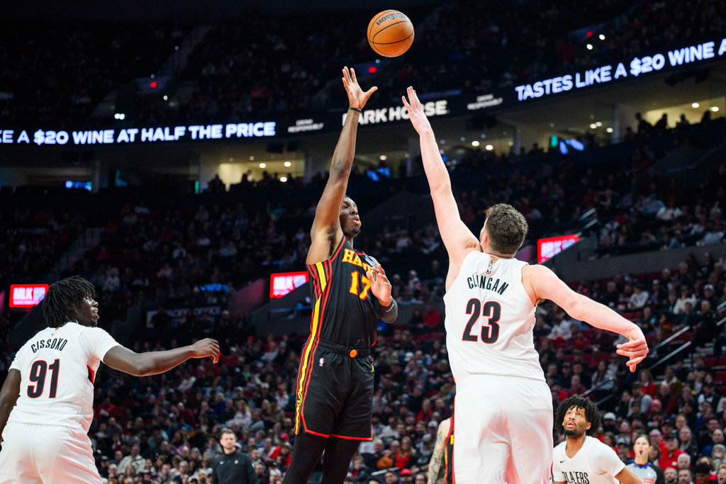 Atlanta Hawks forward Onyeka Okongwu (17) shoots a basket over Portland Trail Blazers center Donovan Clingan (23) during the first half of an NBA basketball game on Thursday, Jan. 15, 2026, in Portland, Ore. (AP Photo/Molly J. Smith)