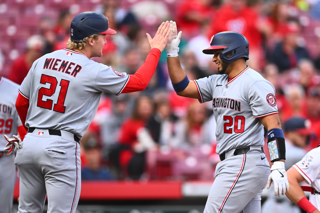 Washington Nationals' Keibert Ruiz, right, celebrates his two-run home run with Joey Wiemer, left, during the second inning of a baseball game against the Cincinnati Reds in Cincinnati, Wednesday, May 13, 2026. (AP Photo/Ben Jackson)