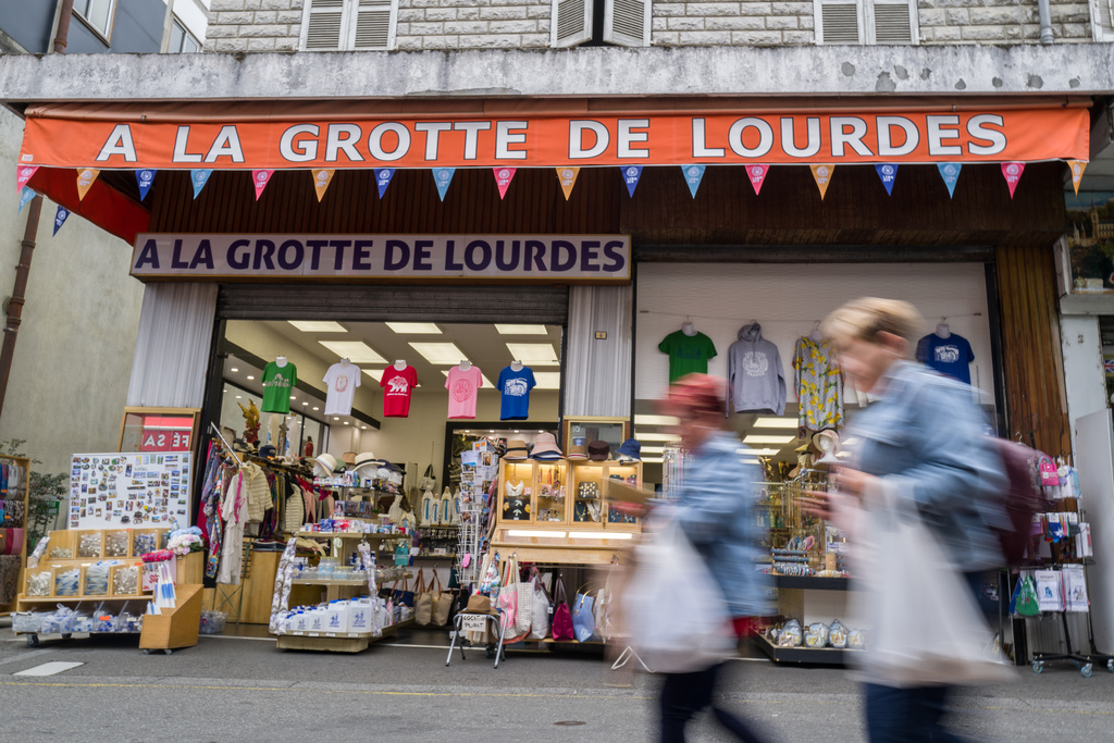 Tourists walk in the streets of Lourdes, southwestern France, Tuesday Sept. 8, 2026. (AP Photo/Fred Scheiber)
