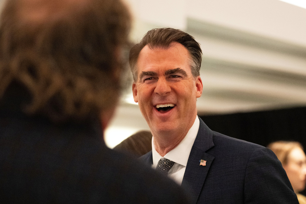 FILE - Oklahoma Gov. Kevin Stitt speaks with an individual following an event at the National Governors Association Winter Meeting, Feb. 19, 2026, in Washington. (AP Photo/Allison Robbert, File)