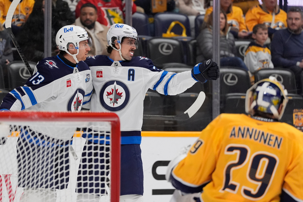 Winnipeg Jets center Gabriel Vilardi (13) celebrates his goal with center Mark Scheifele (55) during the first period of an NHL hockey game against the Nashville Predators, Saturday, Nov. 29, 2025, in Nashville, Tenn. (AP Photo/George Walker IV)