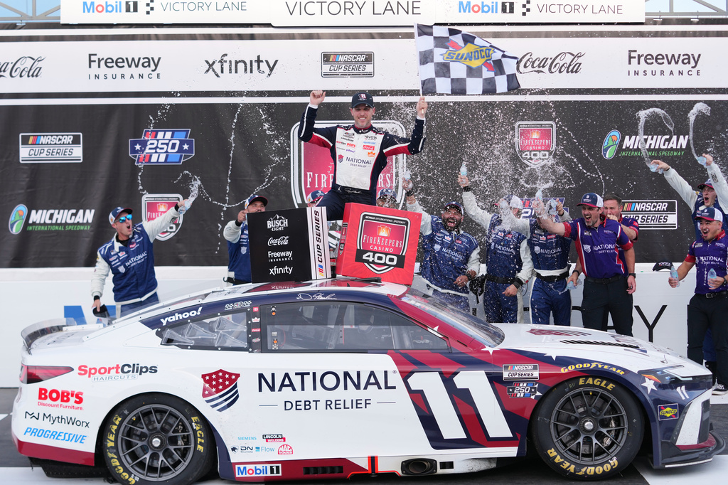 Denny Hamlin celebrates winning a NASCAR Cup Series auto race at Michigan International Speedway in Brooklyn, Mich., Sunday, June 7, 2026. (AP Photo/Paul Sancya)