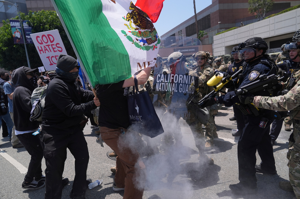 FILE - Protesters clash with authorities in downtown Los Angeles, June 8, 2025, following the night's immigration raid protest. (AP Photo/Jae Hong, File)