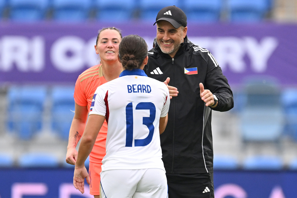 Philippines head coach Mark Torcaso reacts with Angela Beard after defeating Uzbekistan in Women's Asian Cup qualifying match for the World Cup, at Gold Coast Stadium In Robina, Australia, Thursday, March 19, 2026. (Dave Hunt/AAP Image via AP)