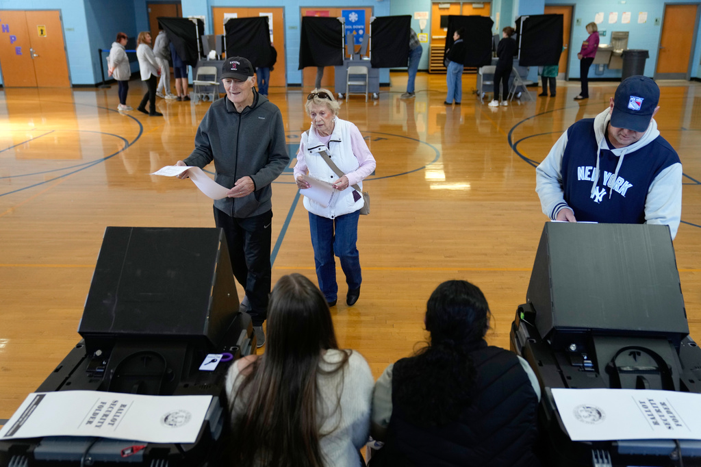 FILE - People vote at a polling site in River Edge, N.J., Nov. 4, 2025. (AP Photo/Seth Wenig, File)