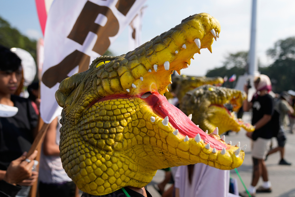A protester wearing a crocodile mask, takes part in an anti-corruption protest in Manila, Philippines on Sunday Nov. 30, 2025. (AP Photo/Aaron Favila)