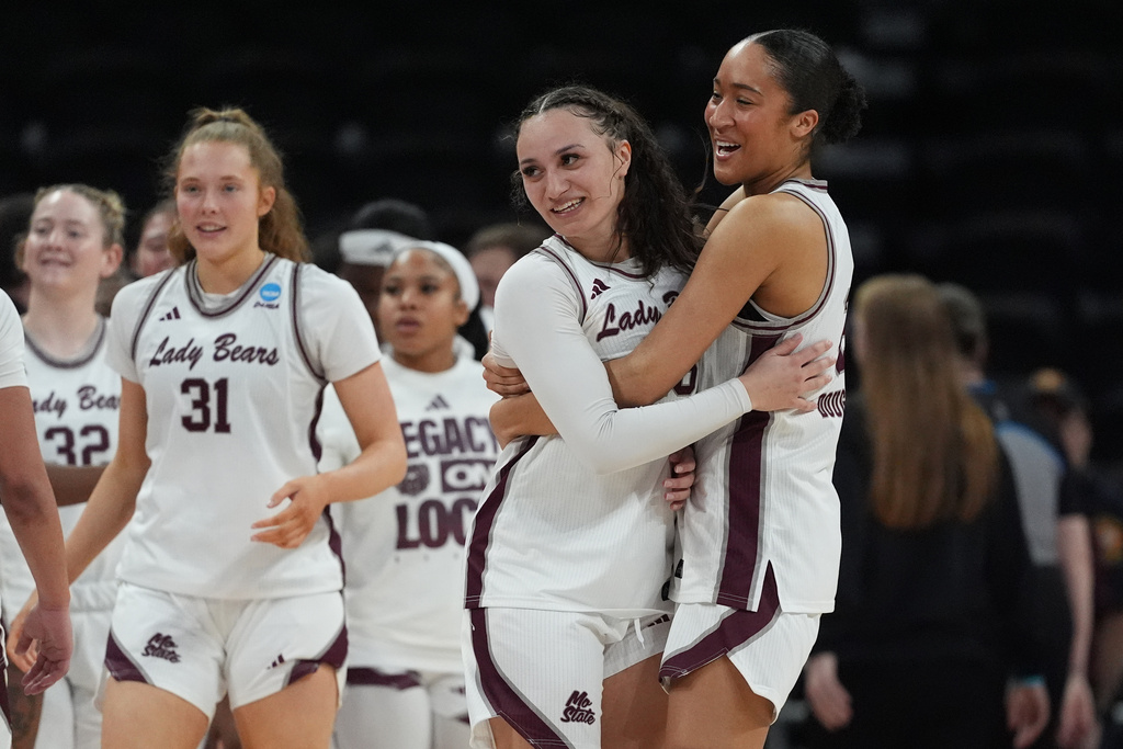 Missouri State forward Lainie Douglas, right, hugs teammate Maiesha Washington as they celebrate their win over Stephen F. Austin in a First Four college basketball game in the NCAA Tournament, Wednesday, March 18, 20206, in Austin, Texas. (AP Photo/Eric Gay)