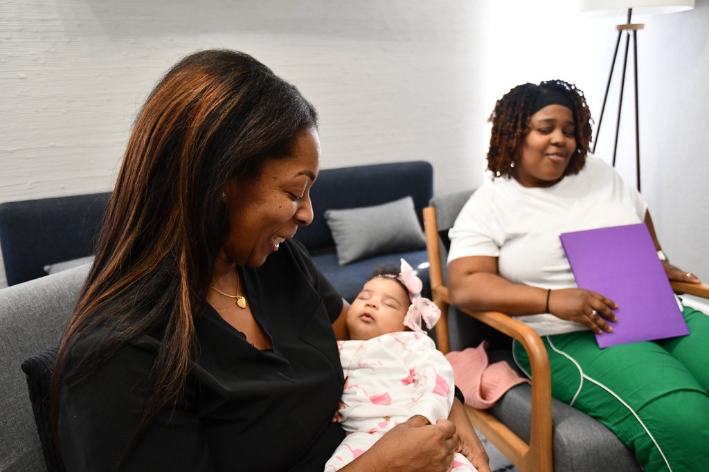 Mary Bey looks on while doula Shanille Bowens holds Bey's daughter, Ca'Mya, during an appointment on Feb. 28, 2026, in Memphis, Tenn. (AP Photo/Kristin M. Hall)