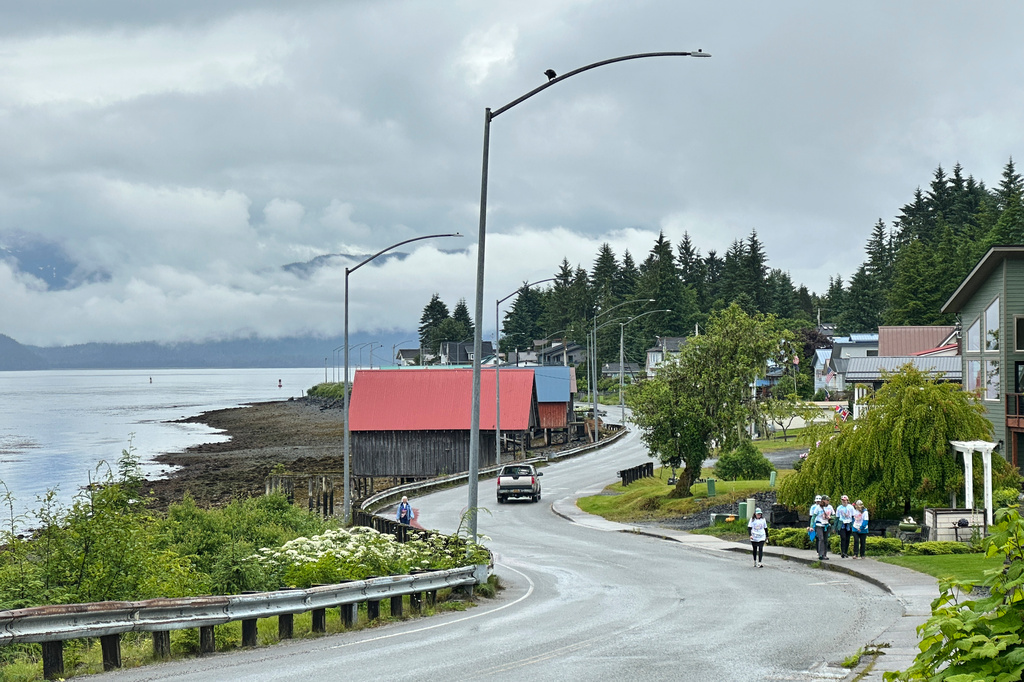 People walk along Nordic Drive, a main street in Petersburg, Alaska, Saturday, July 4, 2026. (AP Photo/Becky Bohrer)