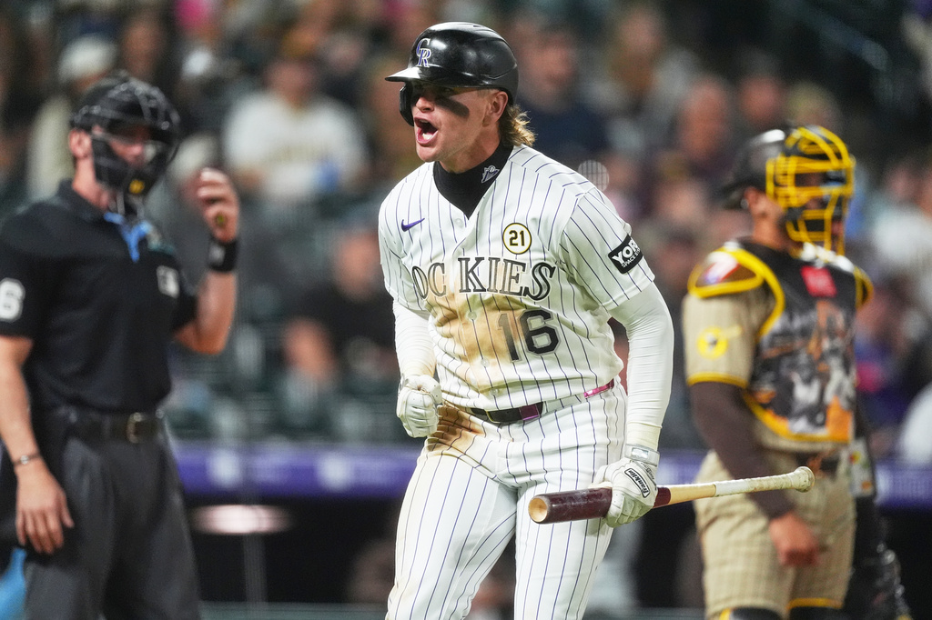 Colorado Rockies' Cole Carrigg turns to the dugout and yells after hitting a three-run home run off San Diego Padres relief pitcher Randy Vásquez in the sixth inning of a baseball game Tuesday, Sept. 15, 2026, in Denver. (AP Photo/David Zalubowski)