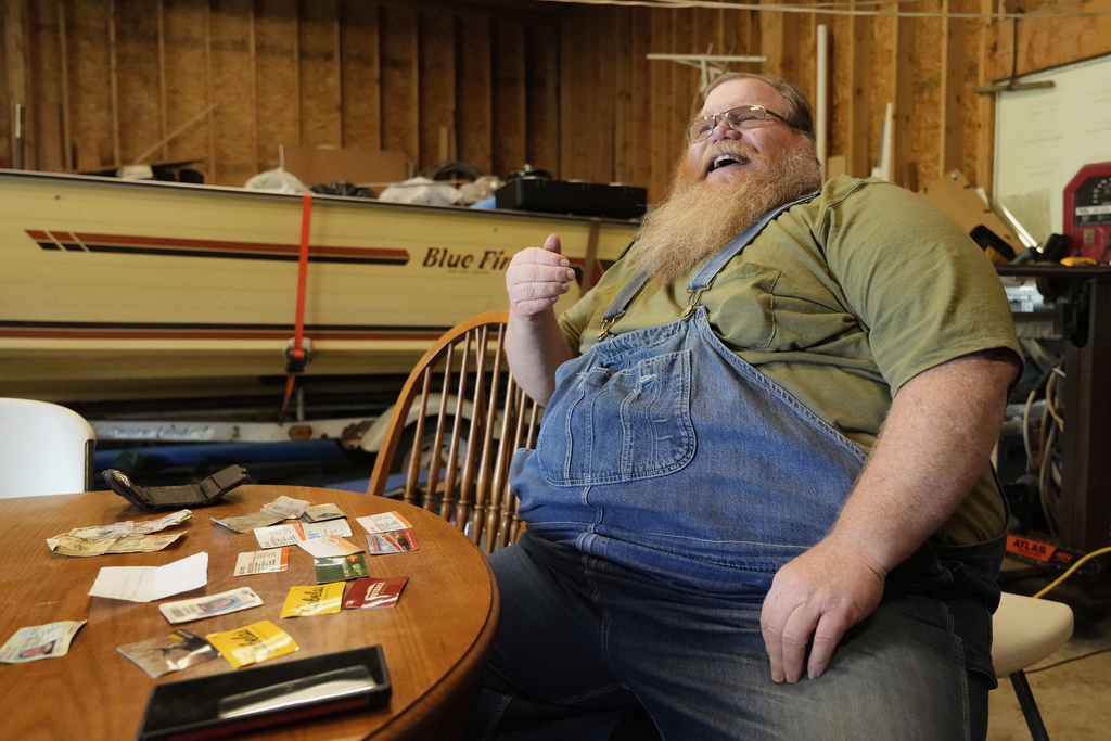 Richard Guilford speaks in an interview in front of items found in his lost wallet Thursday, Aug. 14, 2025, in Petersburg, Mich. (AP Photo/Ryan Sun)