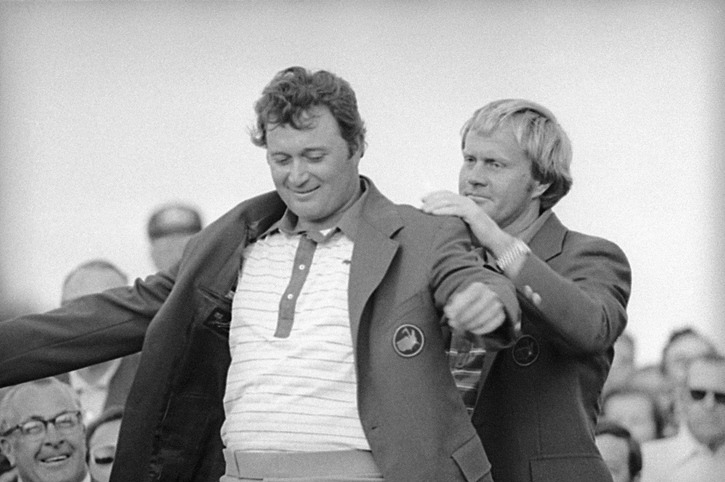 FILE - Jack Nicklaus, right, assists Ray Floyd in putting on his green jacket after Floyd won the Masters Championship, on April 12, 1976, in Augusta, Georgia. (AP Photo, File)
