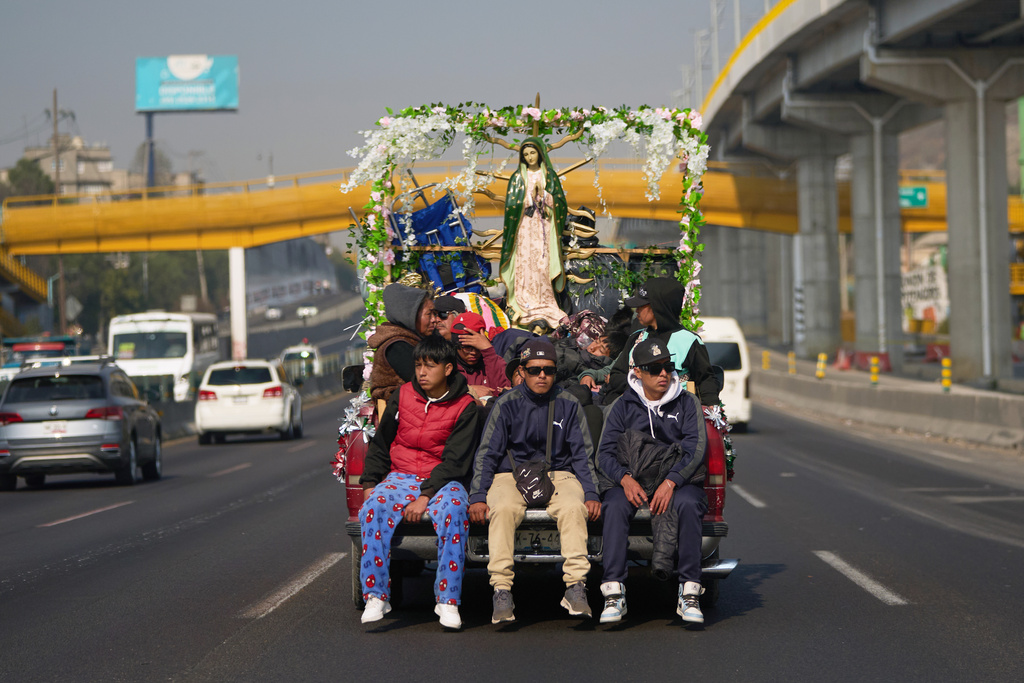 Pilgrims arrive from Puebla for the annual festivities honoring Our Lady of Guadalupe, in Mexico City, Wednesday, Dec. 10, 2025. (AP Photo/Claudia Rosel)