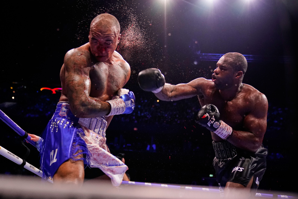 Britain's Daniel Dubois, right, lands a blow on Britain's Fabio Wardley during their WBO World Heavyweight boxing title bout in Manchester, Saturday, May 9, 2026. (AP Photo/Dave Thompson)