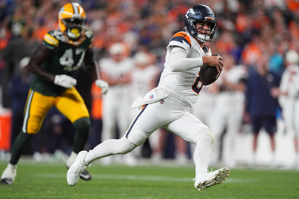 Denver Broncos quarterback Jarrett Stidham (8) runs with the ball against the Green Bay Packers during the second half of an NFL preseason football game Friday, Aug. 21, 2026, in Denver. (AP Photo/David Zalubowski)