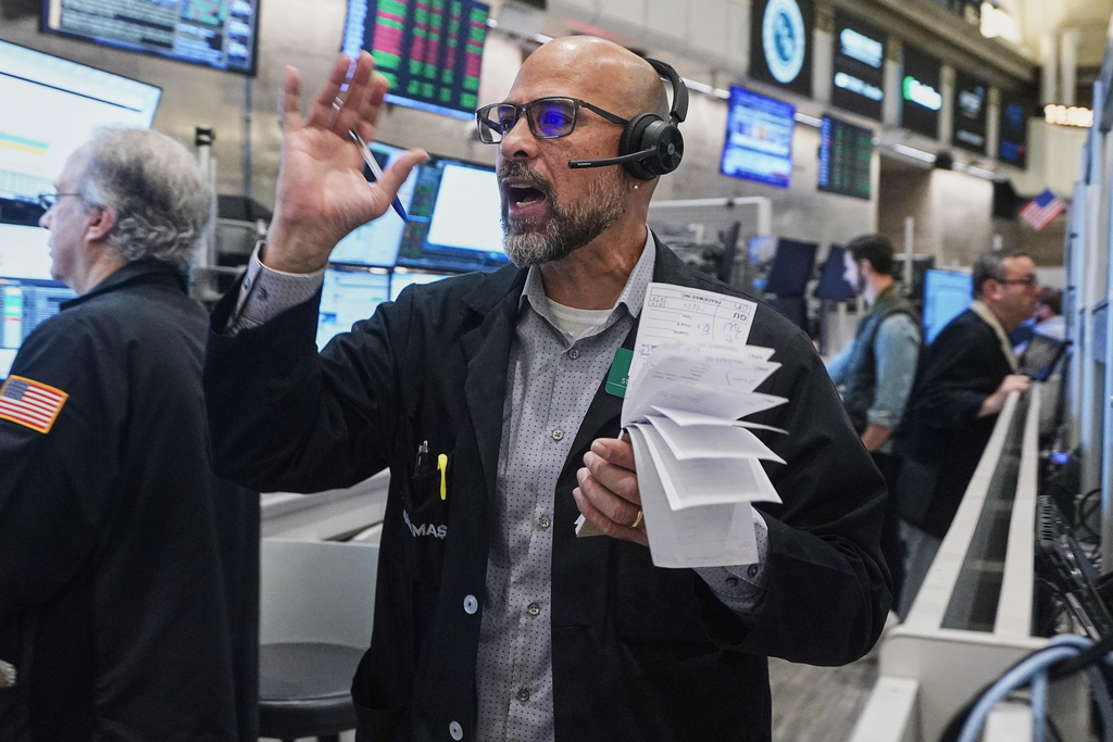 Options trader Steven Rodriguez works on the floor of the New York Stock Exchange, Friday, Nov. 21, 2025. (AP Photo/Richard Drew)