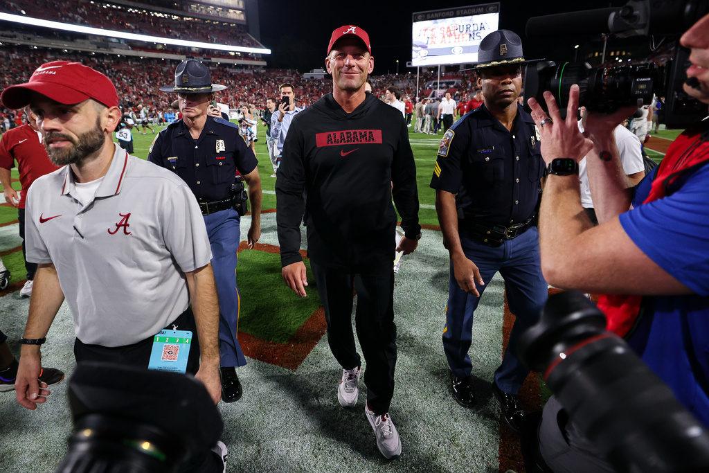Alabama head coach Kalen DeBoer, center, walks off of the field after an NCAA college football game against Georgia, Saturday, Sept. 27, 2025, in Athens, Ga. (AP Photo/Colin Hubbard)