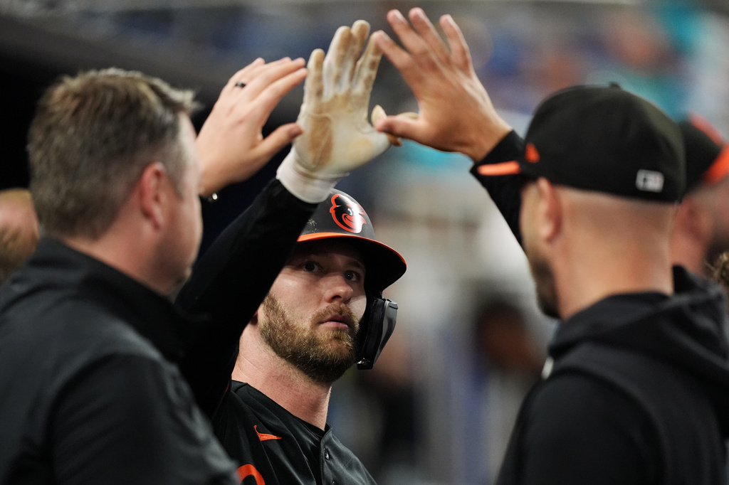 Baltimore Orioles outfielder Taylor Ward, center, celebrates after scoring on a double by Adley Rutschman, during the fifth inning of a baseball game against the Miami Marlins, Wednesday, May 6, 2026, in Miami. (AP Photo/Rebecca Blackwell)