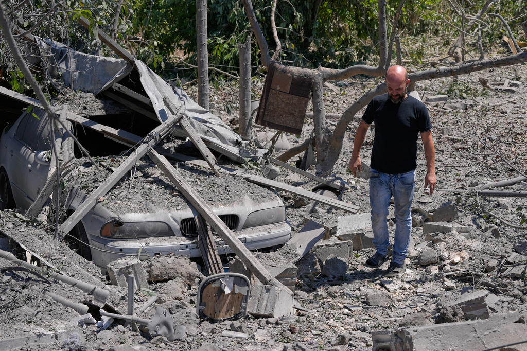 A man checks the site of a destroyed house that was hit in an Israeli airstrike in the village of Burj al-Shamali, southern Lebanon, Thursday, Aug. 6, 2026. (AP Photo/Mohammed Zaatari)