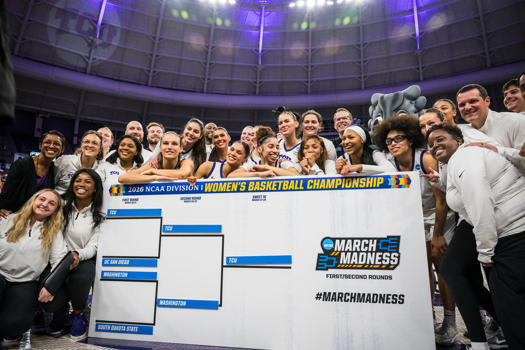 TCU poses for a photo with a March Madness bracket after the second round of the NCAA college basketball tournament Sunday, March 22, 2026, Fort Worth, Texas. (AP Photo/Jessica Tobias)