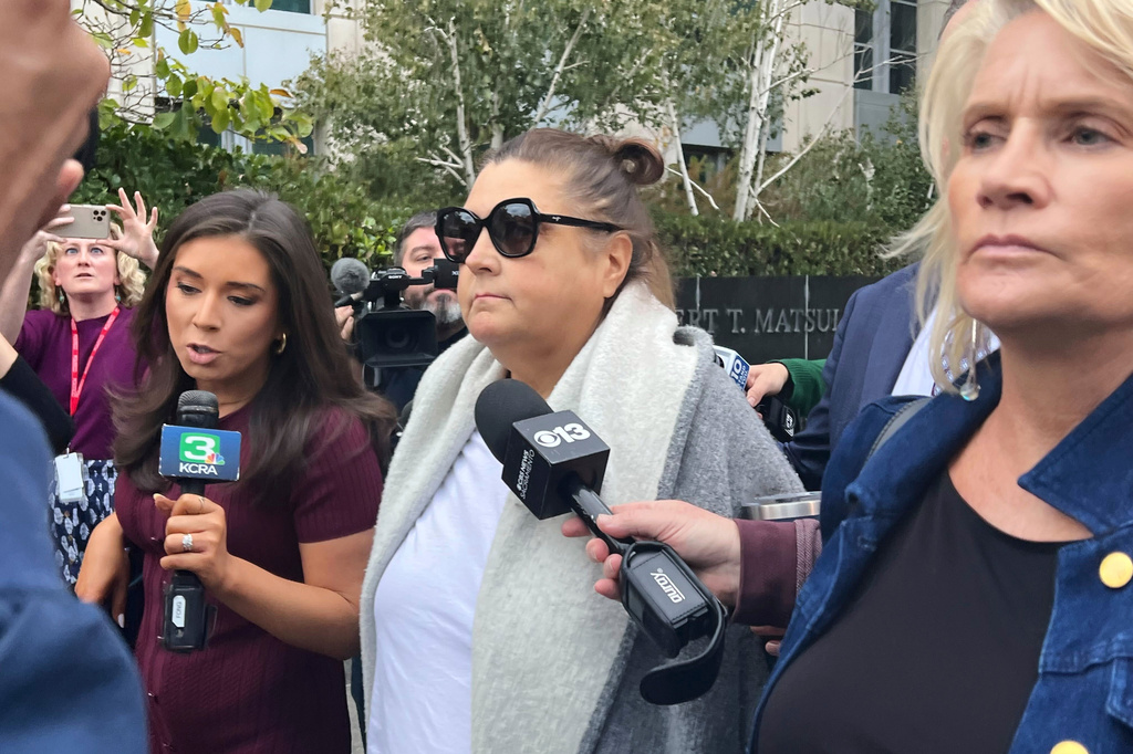 FILE - Dana Williamson, a former top aide to Gov. Gavin Newsom, center, leaves the federal courthouse in Sacramento, Calif., on Nov. 12, 2025. (AP Photo/Sophie Austin, File)