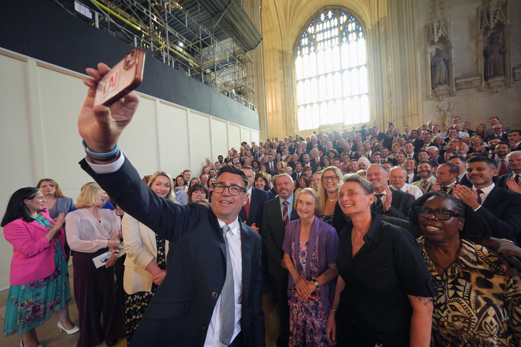 Andy Burnham with colleagues from the Parliamentary Labour Party in Westminster Hall at the Houses of Parliament in central London, as he returns to the House of Commons to take up his seat after winning the Makerfield by-election, Monday June 22, 2026. (Yui Mok/PA via AP)