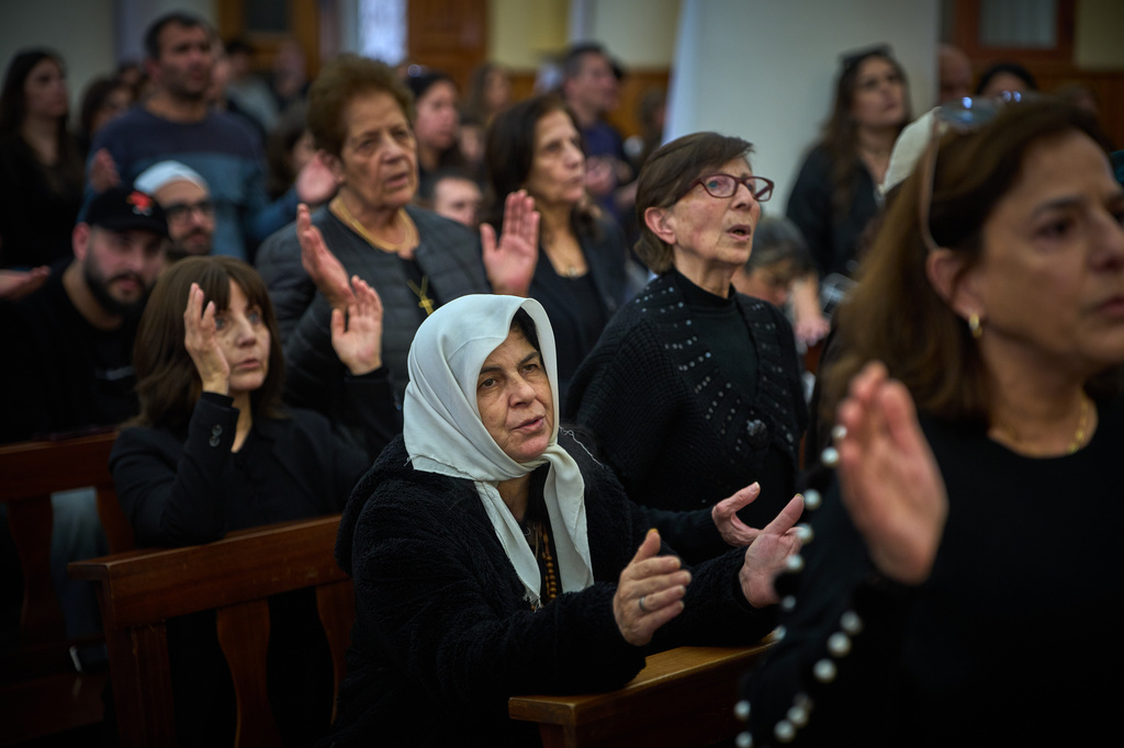 Worshipers pray during Good Friday Mass at St. Anthony Church, which was devoted to expressing solidarity with Christian villagers in southern Lebanon displaced by the war in Jdeideh, a suburb of Beirut, Lebanon, Friday, April 3, 2026. (AP Photo/Emilio Morenatti)