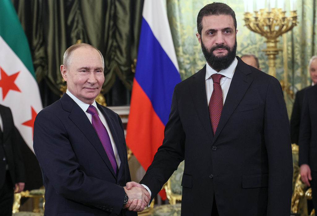 Russian President Vladimir Putin, left, and Syrian interim President Ahmad al-Sharaa pose for a photo during their meeting at the Grand Kremlin Palace in Moscow, on Wednesday, Jan. 28, 2026. (Maxim Shipenkov/Pool Photo via AP)