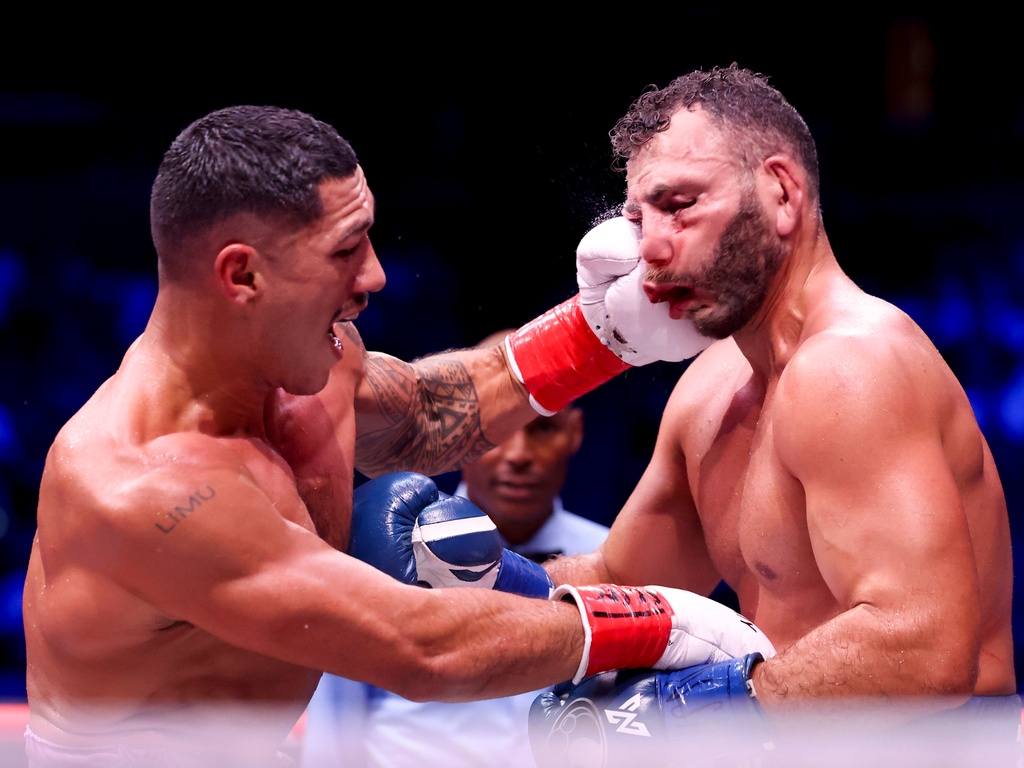Jai Opetaia, left, punches Noel Mikaelian in their cruiserweight championship fight Saturday, Sept. 12, 2026, in Las Vegas. (AP Photo/Ian Maule)