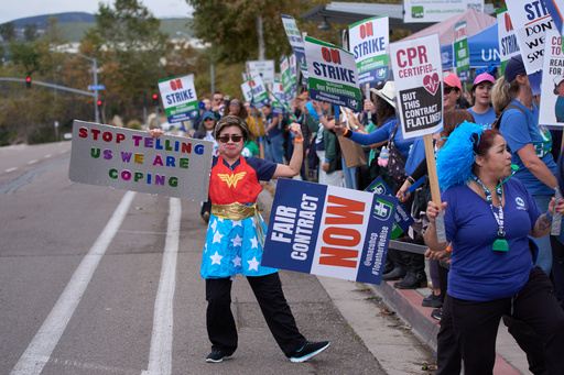 Kaiser Permanente health care workers hold signs and chant slogans while on strike in front of the Kaiser Permanente San Diego Medical Center Tuesday, Oct. 14, 2025, in San Diego. (AP Photo/Gregory Bull) Kaiser Permanente health care workers hold signs and chant slogans while on strike in front of the Kaiser Permanente San Diego Medical Center Tuesday, Oct. 14, 2025, in San Diego. (AP Photo/Gregory Bull)