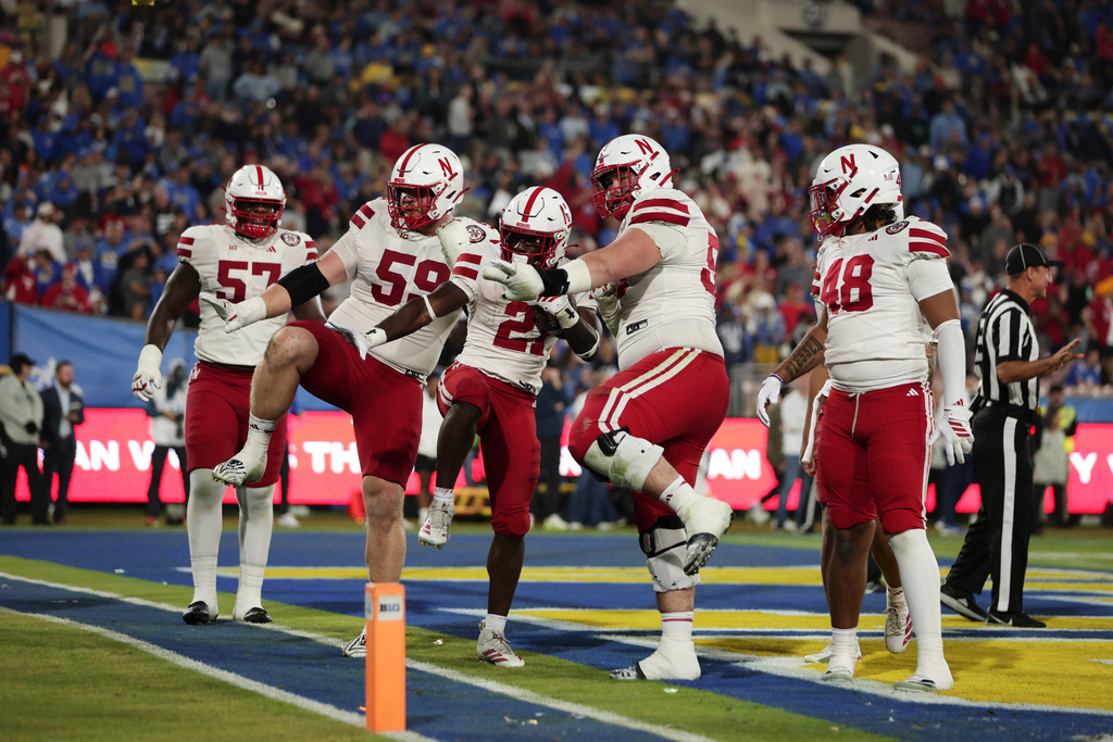 Nebraska running back Emmett Johnson (21) and teammates react after scoring a touch down against UCLA during the first half of an NCAA college football game, Saturday, Nov. 8, 2025, in Pasadena Calif. (AP Photo/Ethan Swope)