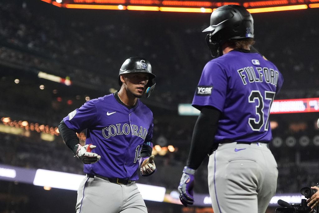 Colorado Rockies' Ezequiel Tovar, left, celebrates after hitting a three-run home run that also scored Braxton Fulford (37) and Brenton Doyle during the fifth inning of a baseball game against the San Francisco Giants in San Francisco, Friday, Sept. 26, 2025. (AP Photo/Jeff Chiu)