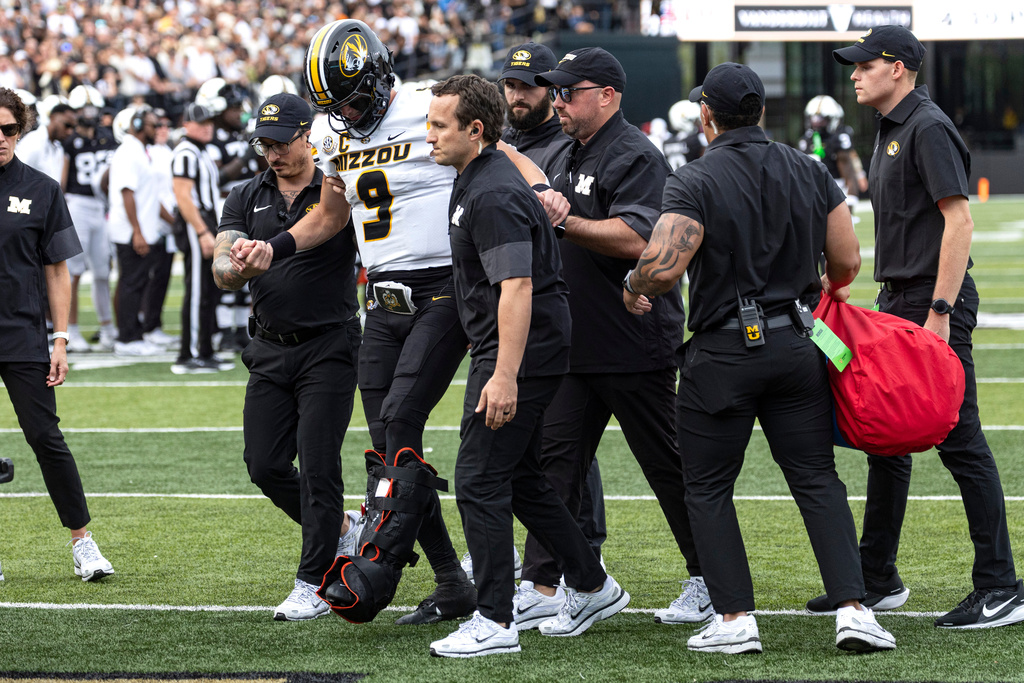 Medical staff assist Missouri quarterback Beau Pribula (9) off the field after being injured during the second half of an NCAA college football game against Vanderbilt, Saturday, Oct. 25, 2025, in Nashville, Tenn. (AP Photo/Wade Payne)