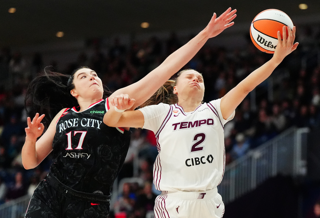Portland Fire's Megan Gustafson (17) fouls Toronto Tempo's Laura Juskaite (2) during second-half WNBA basketball game action in Toronto, Saturday May 23, 2026. (Frank Gunn/The Canadian Press via AP)