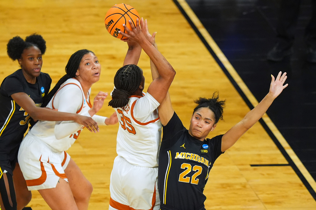 Texas forward Madison Booker (35) shoots on Michigan forward Kendall Dudley (22) during the first half in the Elite Eight of the NCAA college basketball tournament, Monday, March 30, 2026, in Fort Worth, Texas. (AP Photo/LM Otero)