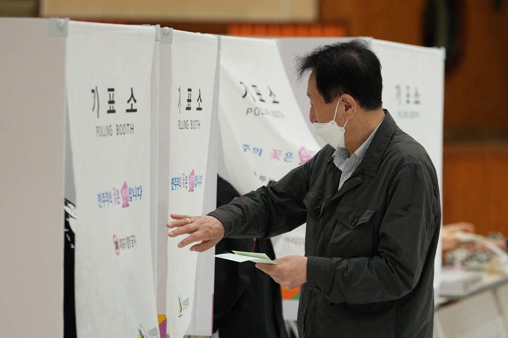 A voter arrives to cast his votes for the nationwide simultaneous local elections at a polling station in Seoul, South Korea, Wednesday, June 3, 2026. (AP Photo/Lee Jin-man)