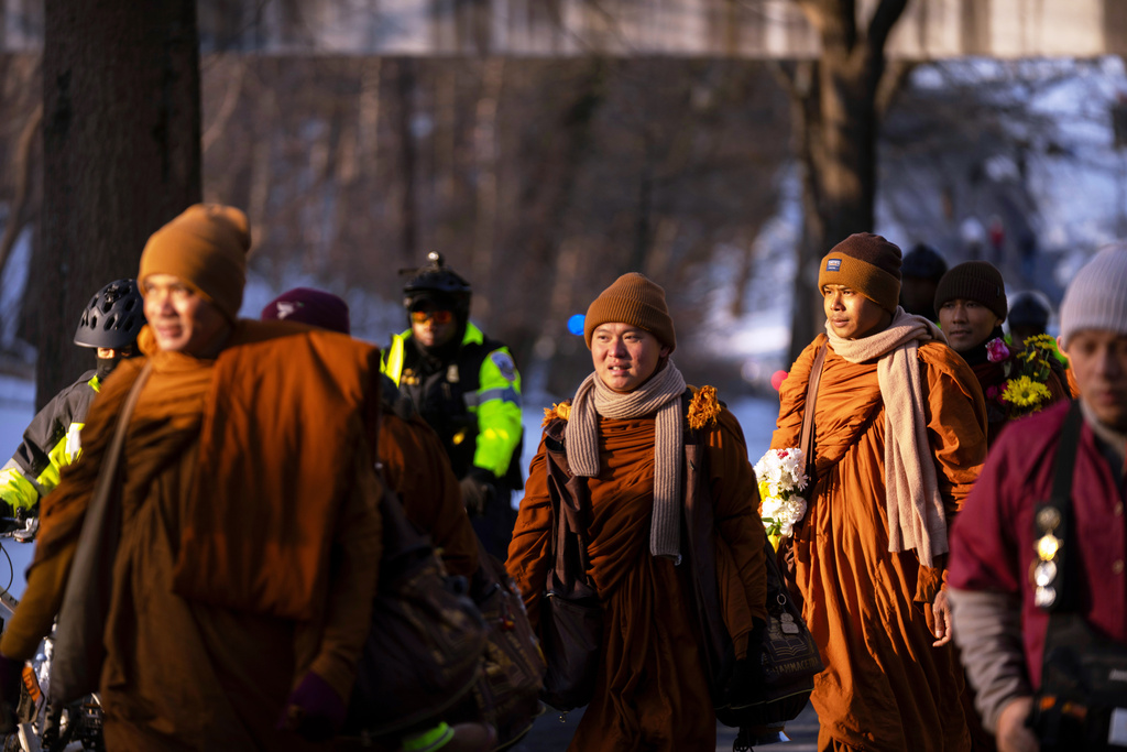Buddhist monks who are participating in a Walk For Peace walk through a neighborhood on Tuesday, Feb. 10, 2026, in Washington. (AP Photo/Mark Schiefelbein)