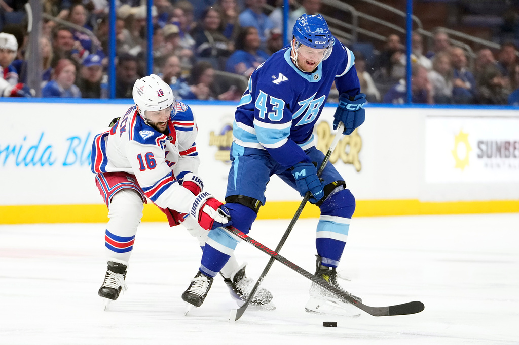 New York Rangers center Vincent Trocheck (16) and Tampa Bay Lightning defenseman Darren Raddysh (43) battle for the puck during the third period of an NHL hockey game Wednesday, April 15, 2026, in Tampa, Fla. (AP Photo/Chris O'Meara)