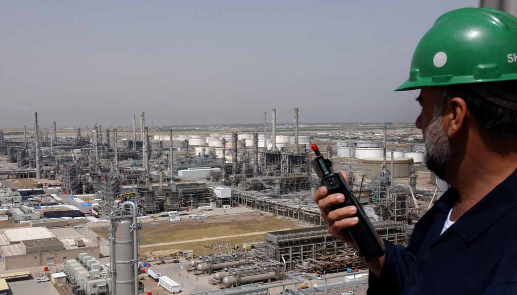 FILE - A Kuwaiti oil worker talks on his radio at Mina Abdulah Oil Refinery, 50 Km South of Kuwait City in this file photo taken April 2005. (AP Photo/Gustavo Ferrari, File)