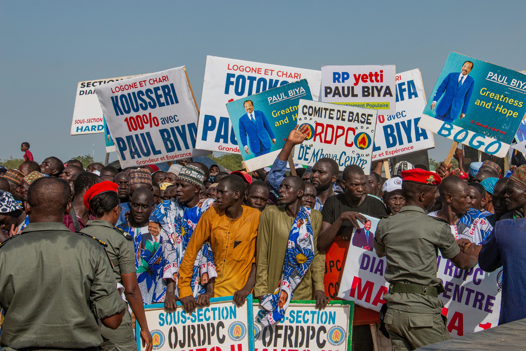 Supporters of Cameroon People's Democratic Movement (CPDM) hold placards bearing the image of President Paul Biya during a political rally at Lamido Yaya Dairou Stadium in Maroua, Cameroon, Tuesday, Oct. 7, 2025. (AP Photo/Welba Yamo Pascal)
