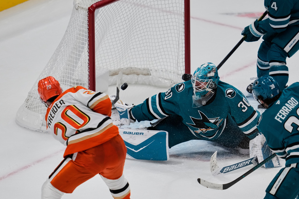 Anaheim Ducks left wing Chris Kreider (20) scores a goal against San Jose Sharks goaltender Yaroslav Askarov (30) during the third period of an NHL hockey game Saturday, Oct. 11, 2025, in San Jose, Calif. (AP Photo/Godofredo A. Vásquez)