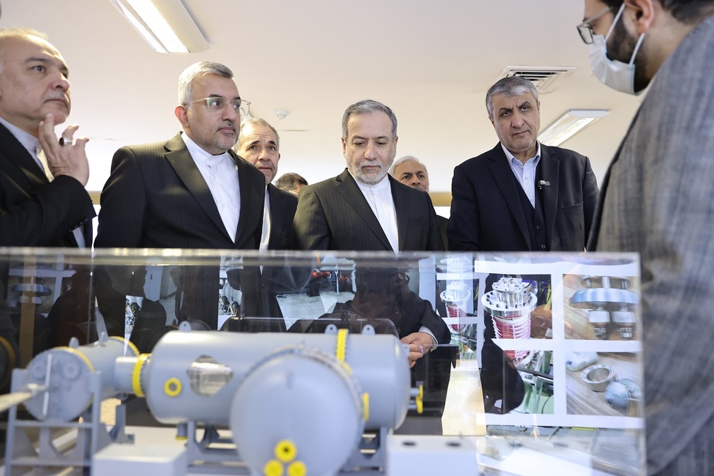 In this photo, released on Monday, Nov. 10, 2025 by the Atomic Energy Organization of Iran, Foreign Minister Abbas Araghchi, center, listens to explanations as he visits an exhibition of the country's nuclear achievements during his tour to the Atomic Energy Organization, while he is accompanied by the head of the Atomic Energy Organization of Iran, Mohammad Eslami, second right, in Tehran, Iran. (Atomic Energy Organization of Iran via AP)