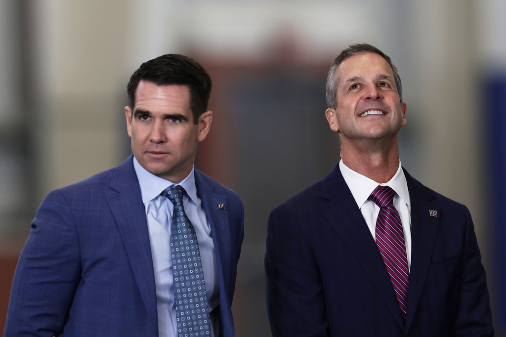 New York Giants head coach John Harbaugh, right, waits along with general manager Joe Schoen to be introduced during a news conference at the teams NFL football training facility Tuesday, Jan. 20, 2026, in East Rutherford, N.J. (AP Photo/Adam Hunger)