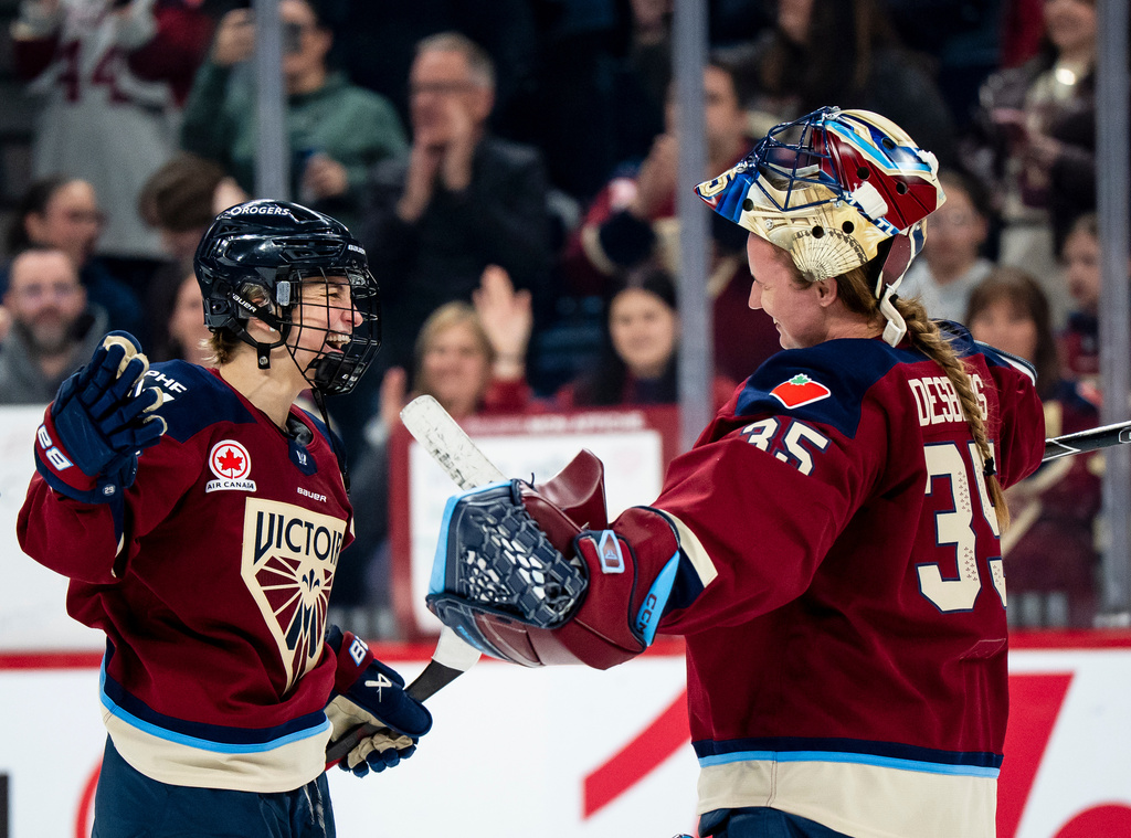 Montreal Victoire's Marie-Philip Poulin (29) celebrates with goaltender Ann-Renee Desbiens (35) after defeating the Minnesota Frost in PWHL playoff hockey action in Laval, Que., on Tuesday, May 12, 2026. (Christopher Katsarov/The Canadian Press via AP)