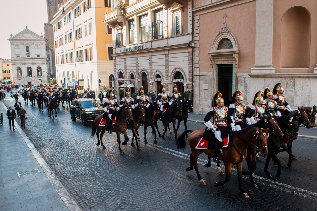 Mounted cuirassiers escort Pope Leo XIV as he arrives in a car at the Quirinale Presidential Palace in Rome, Tuesday, Oct. 14, 2025. (Valentina Stefanelli/LaPresse via AP)