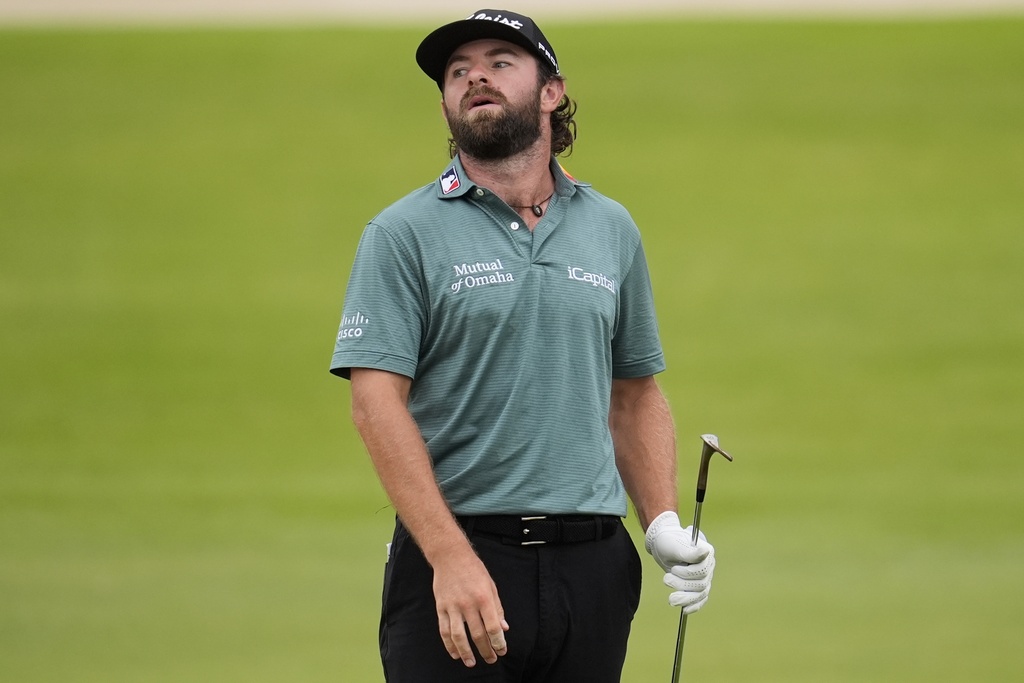 Cameron Young reacts to his putt on the 18th green during the third round of the Tour Championship golf tournament, Saturday, Aug. 23, 2025, in Atlanta. (AP Photo/Mike Stewart)