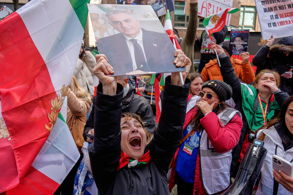 A person holds an image of Reza Pahlavi during a rally in reaction to U.S. and Israeli strikes on Iran and in support of Pahlavi, the exiled son of Iran’s last shah overthrown during the 1979 Islamic Revolution, Sunday, March 1, 2026 in New York. (AP Photo/Adam Gray)