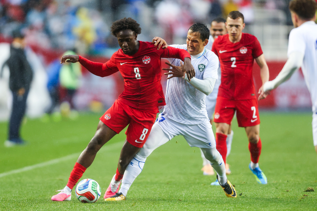 Canada's Ismael Kone (8) and Uzbekistan's Otabek Shukurov, second from left, vie for the ball during the first half of an international friendly soccer match in Edmonton, Alberta, Monday, June 1, 2026. (Codie McLachlan/The Canadian Press via AP)