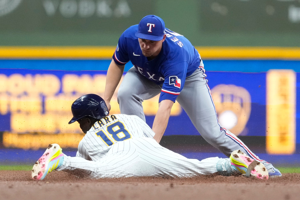 Texas Rangers' Corey Seager tags Milwaukee Brewers' Luis Lara (18) out at second base during the second inning of a baseball game Saturday, Aug. 29, 2026, in Milwaukee. (AP Photo/Aaron Gash)